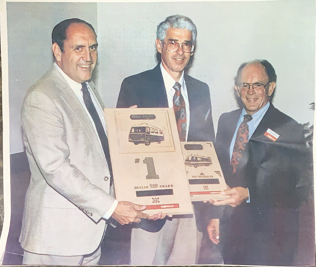 Open road with RV casting a long shadow